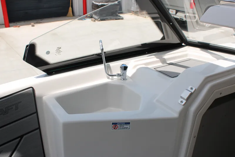 Slide: The Image of 2025 Starcraft 230 boat interior with sink and faucet, showcasing modern design features. - 11