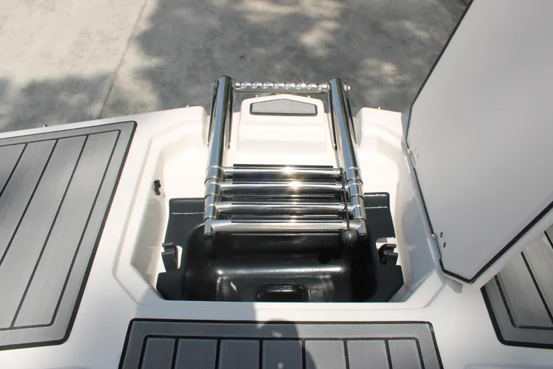 Slide: The Image of 2025 Starcraft 230 boat with a stainless steel retractable ladder on deck. - 15