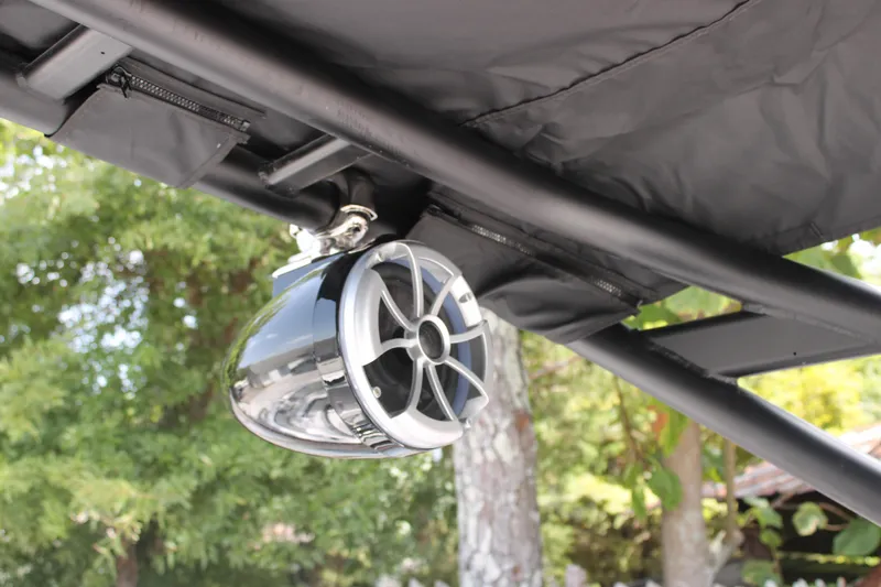 Slide: The Image of Speaker mounted on a 2025 Starcraft 230 boat, under a black canopy. - 18