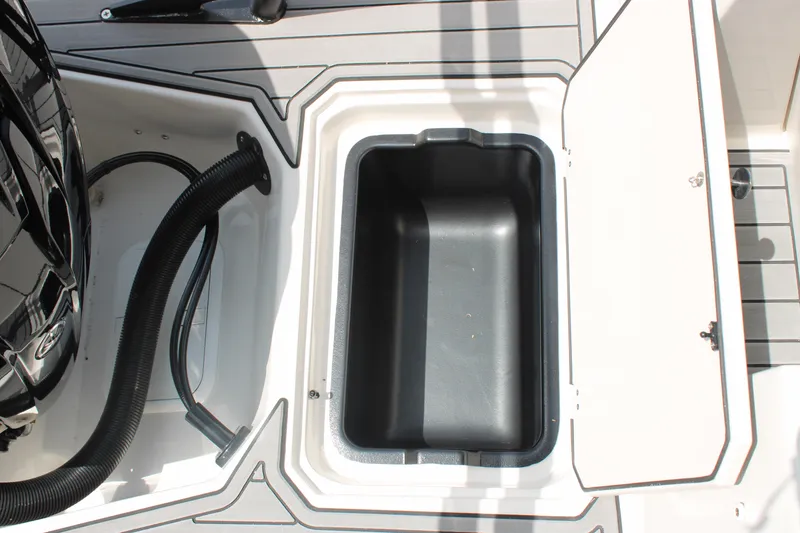 Slide: The Image of Open storage compartment on 2025 Starcraft 230 boat deck. - 21