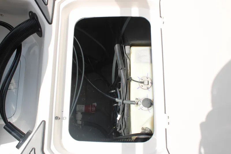 Slide: The Image of Compartment view of 2025 Starcraft 230 boat, showcasing internal wiring and components. - 22
