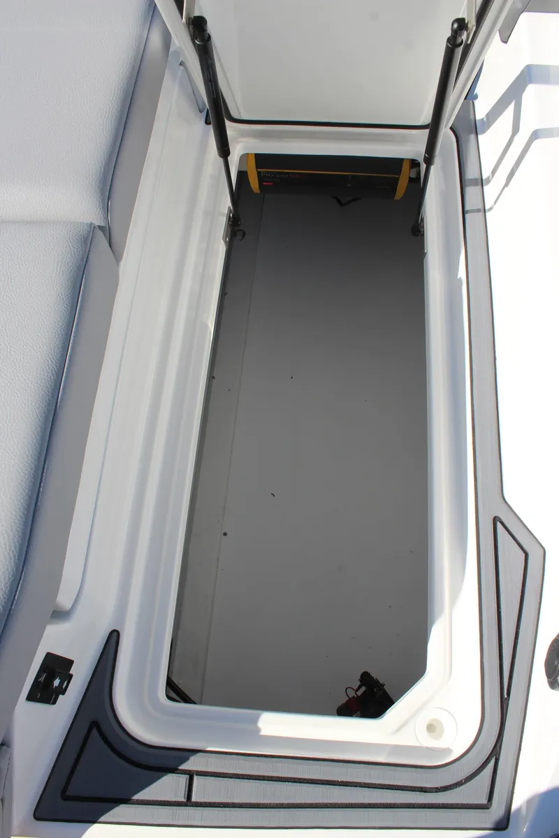 Slide: The Image of 2025 Cobalt CS23 boat storage compartment, open and empty. - 12