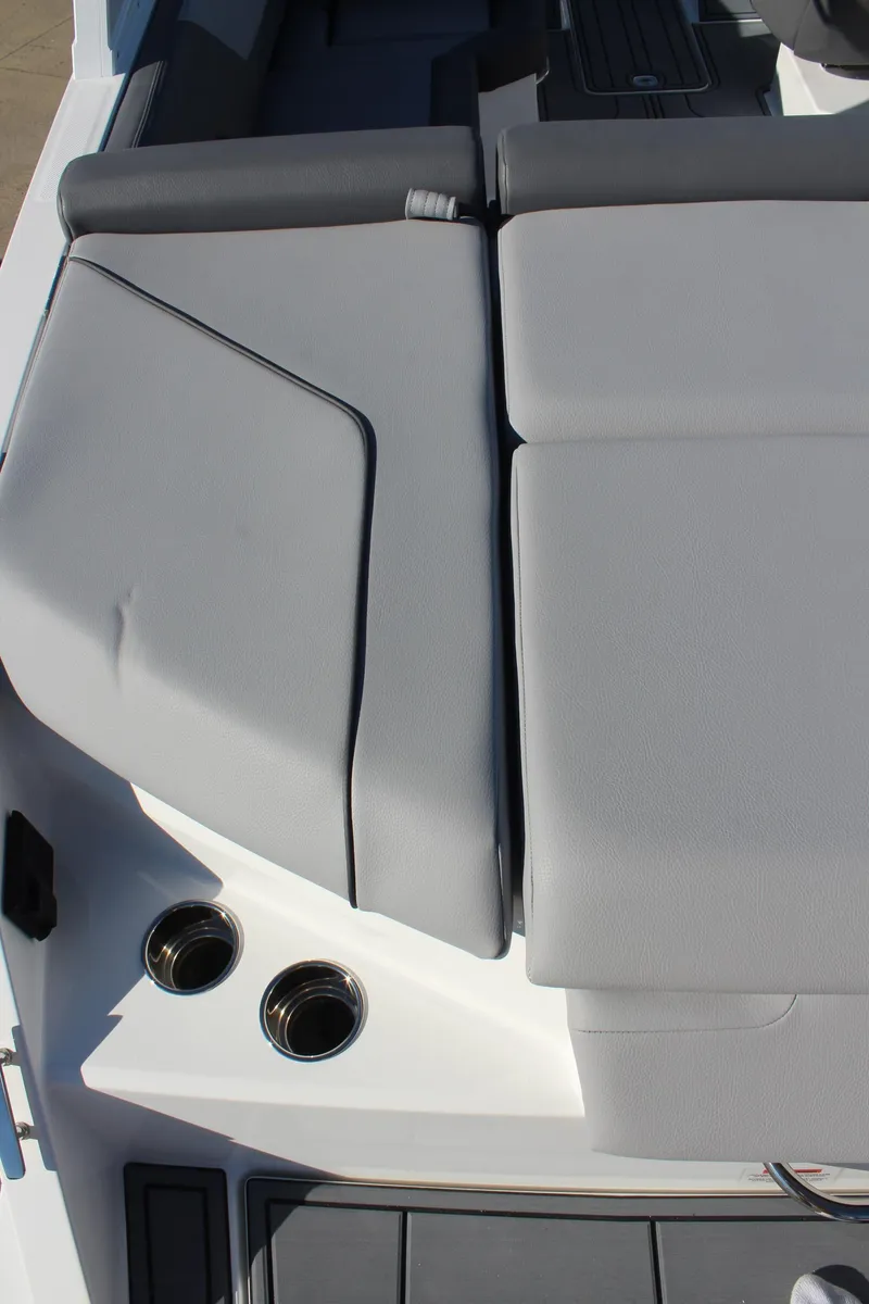 Slide: The Image of 2025 Cobalt CS23 boat interior with gray seating and cup holders. - 13