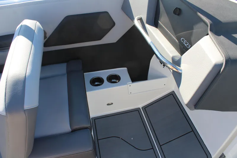 Slide: The Image of 2025 Cobalt CS23 boat interior with seating and cup holders. - 24