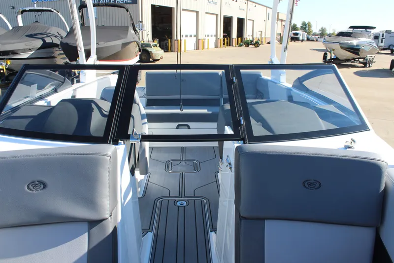 Slide: The Image of 2025 Cobalt CS23 boat interior with gray seating and open deck. - 32