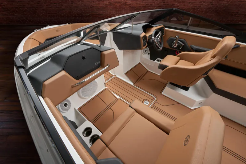 Slide: The Image of 2025 Cobalt CS23 boat interior with luxurious tan leather seating and modern dashboard design. - 37