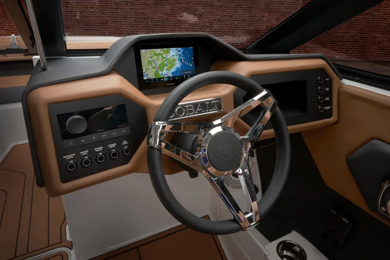 Slide: The Image of 2025 Cobalt CS23 boat dashboard with modern steering wheel and navigation display. - 38