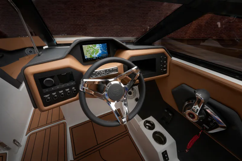 Slide: The Image of 2025 Cobalt CS23 boat dashboard with modern steering wheel and navigation display. - 39