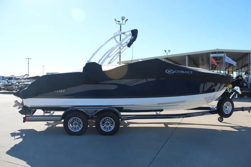 Slide: The Image of 2025 Cobalt CS23 boat on trailer, covered and parked outdoors. - 6