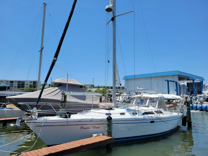 The Image of 2003 Catalina 42 Mk2 sailboat docked at marina under clear blue sky. - 0
