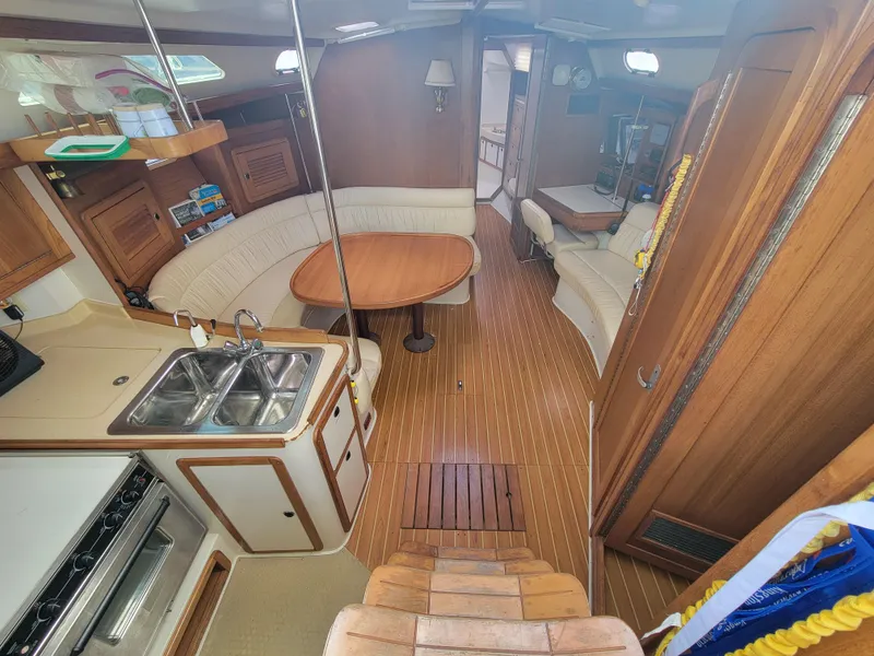 Slide: The Image of Interior of 2003 Catalina 42 Mk2 sailboat with wood finish and cozy seating area. - 2