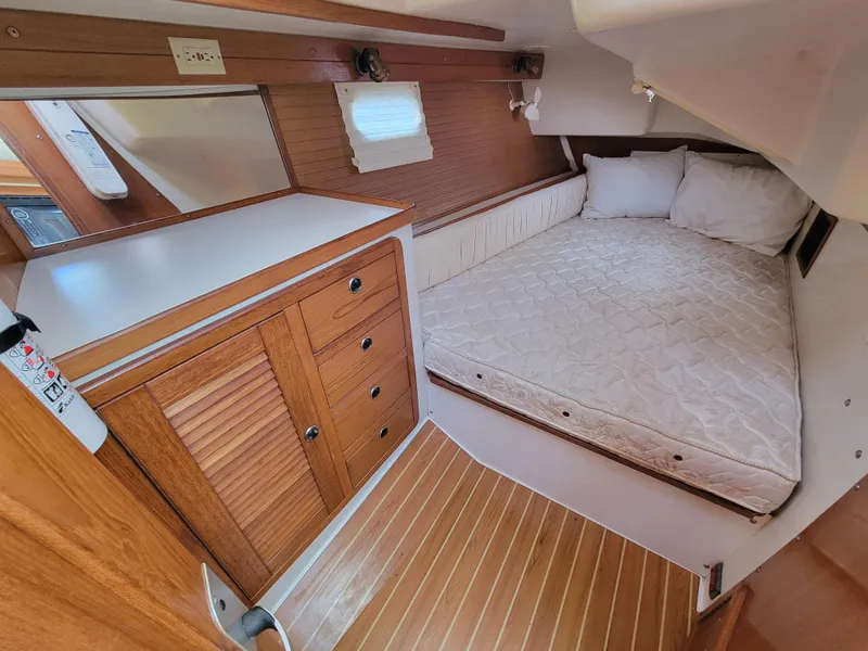 Slide: The Image of Cozy cabin interior of 2003 Catalina 42 Mk2 sailboat with wooden cabinetry and bed. - 6