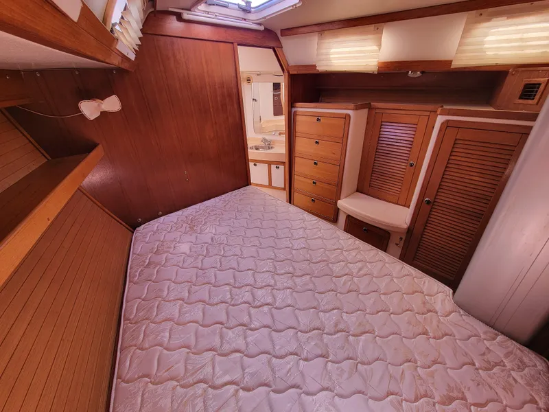 Slide: The Image of Interior cabin of 2003 Catalina 42 Mk2 sailboat with bed and wooden storage. - 8