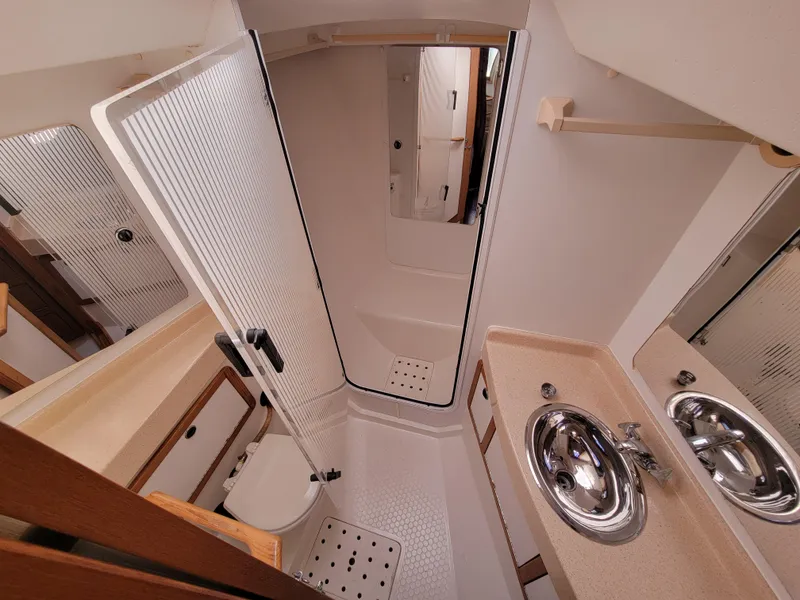 Slide: The Image of 2003 Catalina 42 Mk2 yacht bathroom with shower, sink, and toilet. - 9