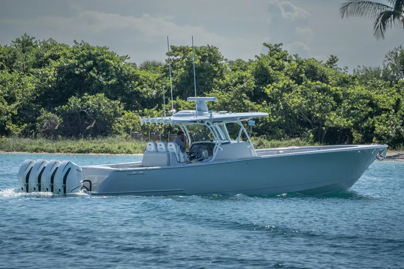 Slide: The Image of 2023 Valhalla Boatworks V-41 cruising on blue water near lush greenery. - 0