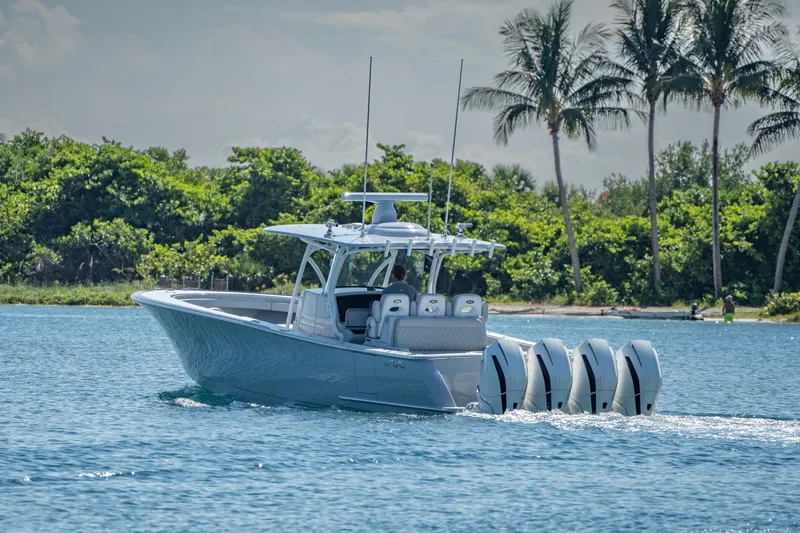 Slide: The Image of 2023 Valhalla Boatworks V-41 cruising on a sunny day with palm trees in the background. - 3