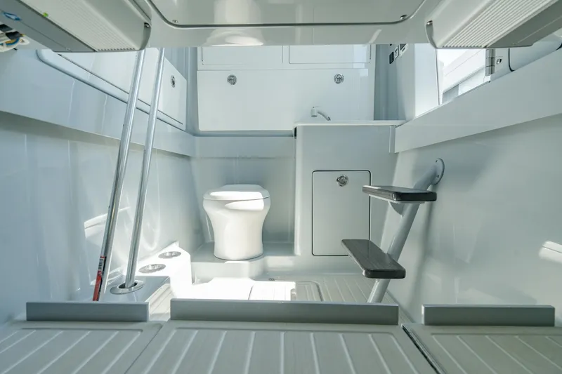 Slide: The Image of Interior of 2023 Valhalla Boatworks V-41, featuring a modern bathroom with toilet and storage. - 32