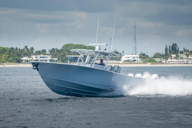 Slide: The Image of 2023 Valhalla Boatworks V-41 cruising on open water near coastal homes. - 6