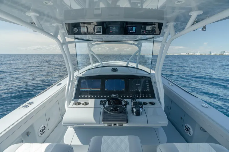 Slide: The Image of 2023 Valhalla Boatworks V-41 helm with advanced navigation system on open sea. - 7