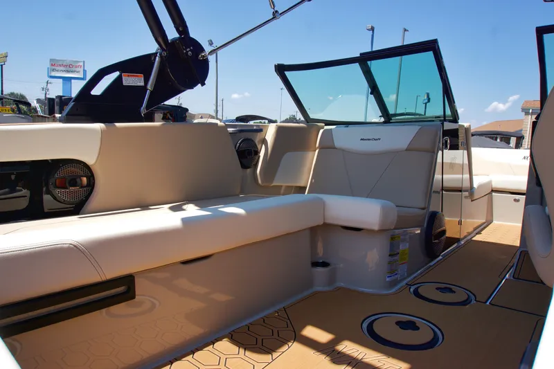 Slide: The Image of 2025 MasterCraft NXT22 boat interior with beige seating and modern design. - 11