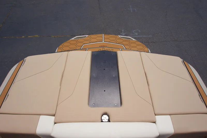 Slide: The Image of 2025 MasterCraft NXT22 boat with beige seating and hexagonal-patterned deck. - 13
