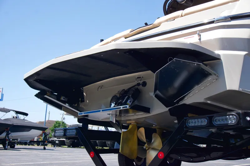 Slide: The Image of 2025 MasterCraft NXT22 boat rear view with propeller and trailer. - 14