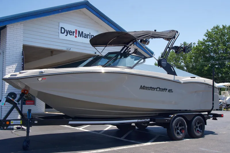 Slide: The Image of 2025 MasterCraft NXT22 boat on trailer at Dyer Marine dealership. - 2