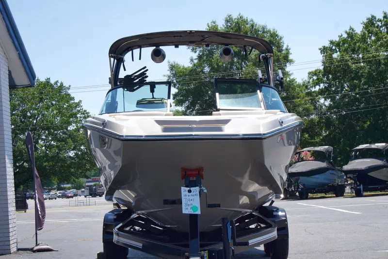 Slide: The Image of 2025 MasterCraft NXT22 boat on trailer, parked outdoors. - 3