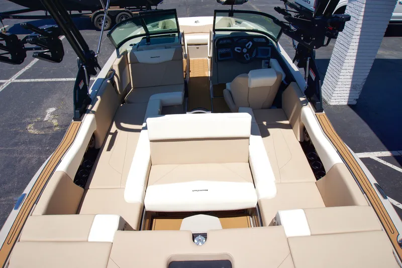 Slide: The Image of 2025 MasterCraft NXT22 boat interior with beige seating and modern dashboard. - 8