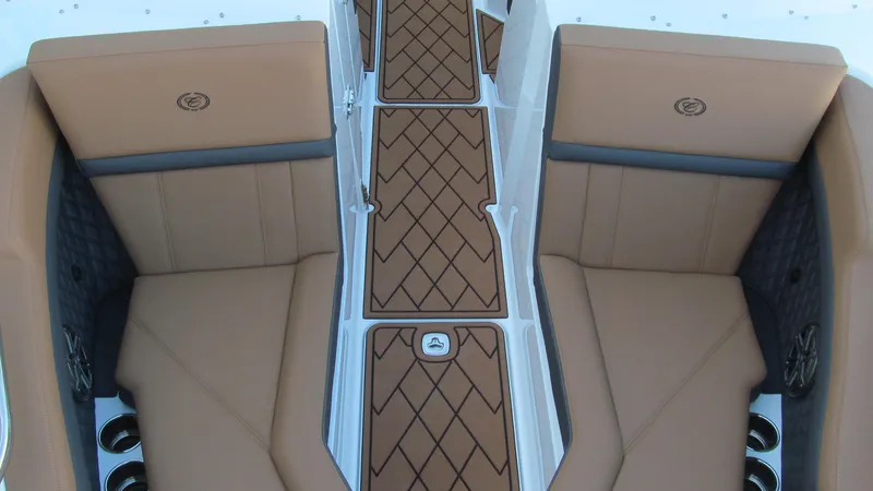 Slide: The Image of 2025 Cobalt R4 boat interior with tan leather seating and diamond-patterned flooring. - 10