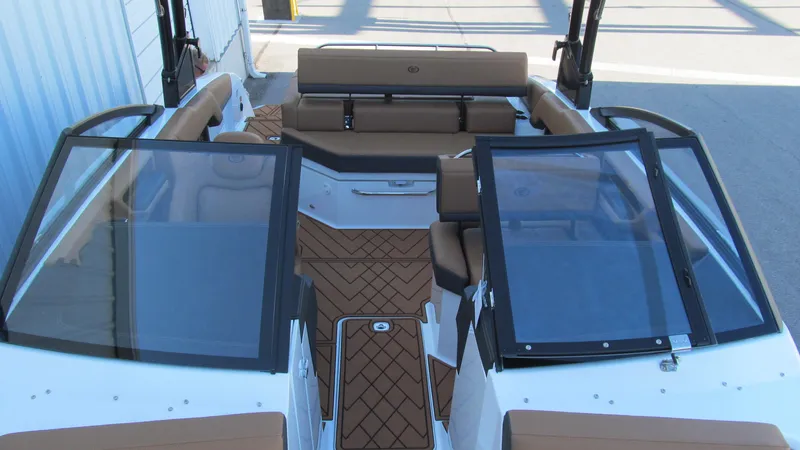 Slide: The Image of 2025 Cobalt R4 boat interior with tan seating and sleek design. - 11