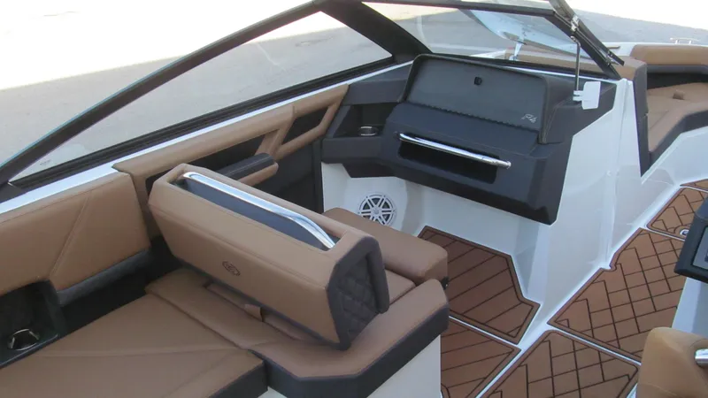 Slide: The Image of 2025 Cobalt R4 boat interior with brown seating and modern dashboard design. - 7