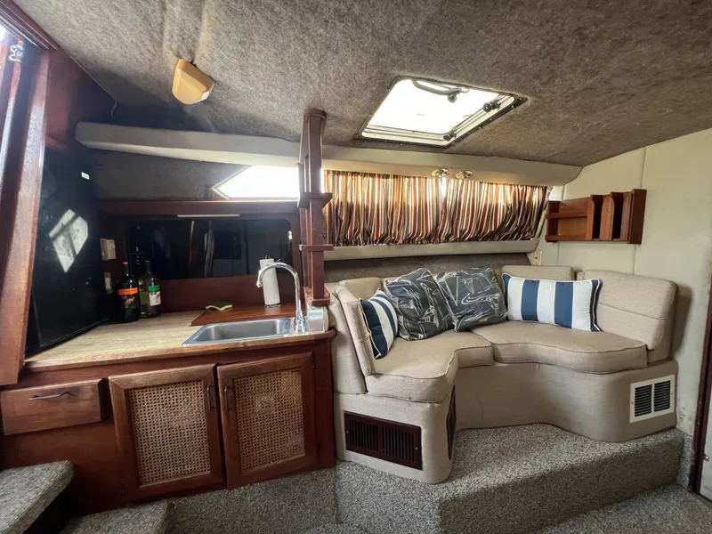 Slide: The Image of Interior of 1985 Bayliner 3250 Conquest with cozy seating and kitchenette. - 16