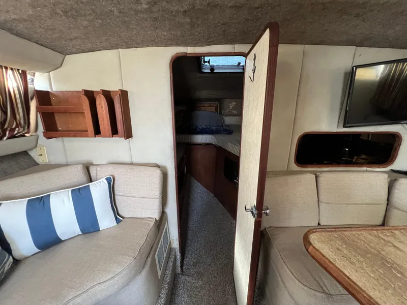 Slide: The Image of Interior of 1985 Bayliner 3250 Conquest boat with cozy seating and modern amenities. - 25