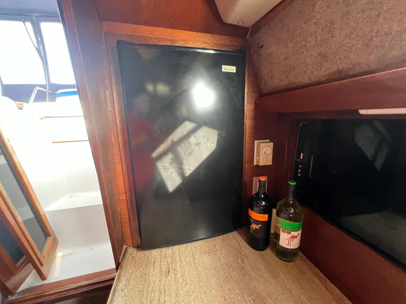 Slide: The Image of Interior of 1985 Bayliner 3250 Conquest with fridge and countertop. - 27