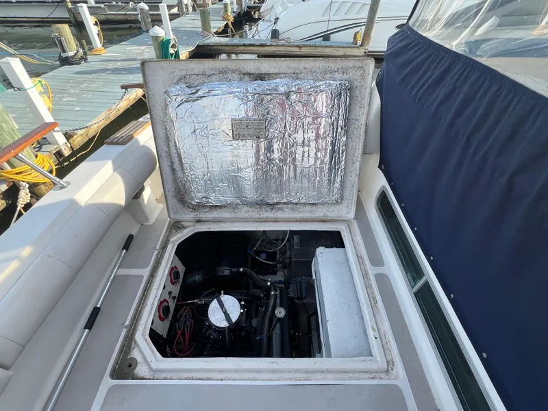 Slide: The Image of Open engine compartment of 1985 Bayliner 3250 Conquest boat at dock. - 31
