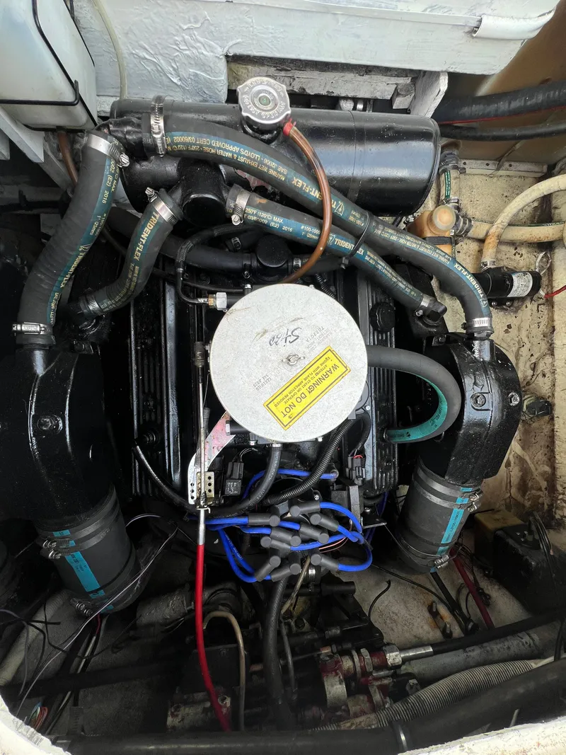 Slide: The Image of Engine compartment of a 1985 Bayliner 3250 Conquest boat, showing hoses and components. - 33