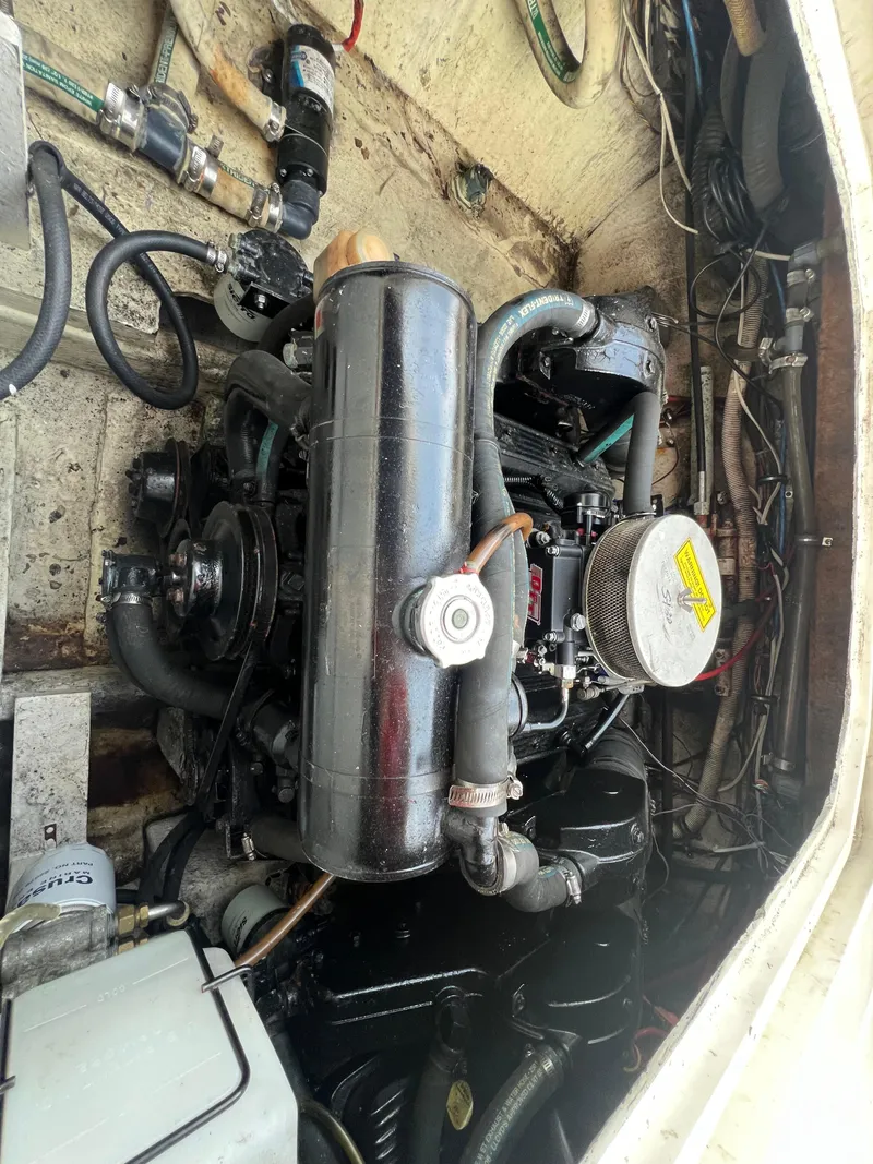Slide: The Image of Engine compartment of 1985 Bayliner 3250 Conquest boat, showcasing mechanical components. - 34