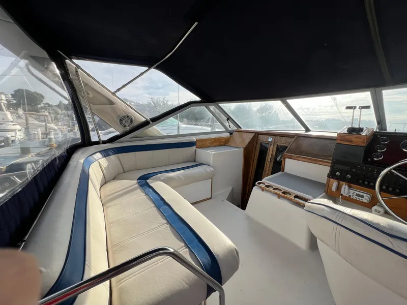 Slide: The Image of Interior of 1985 Bayliner 3250 Conquest boat with seating and control panel. - 6