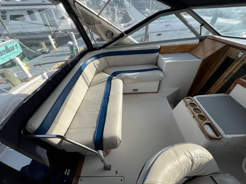 Slide: The Image of Interior of 1985 Bayliner 3250 Conquest boat with white and blue seating. - 9