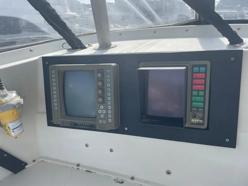 Slide: The Image of 1983 Luhrs 340 boat dashboard with vintage navigation equipment and controls. - 12