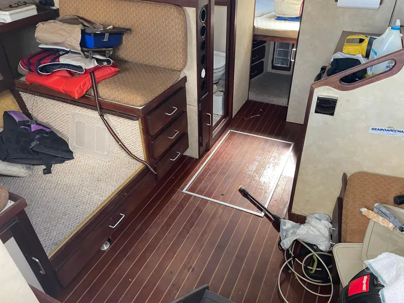 Slide: The Image of Interior of 1983 Luhrs 340 boat with wooden flooring and seating area. - 14