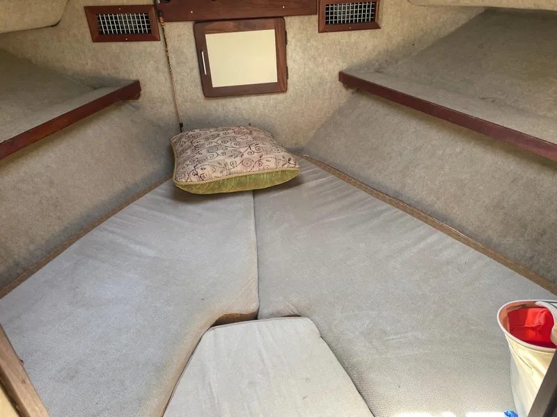 Slide: The Image of Interior cabin of a 1983 Luhrs 340 boat with a cozy sleeping area. - 15