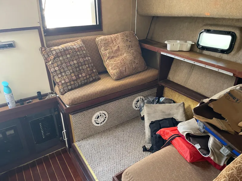Slide: The Image of Interior of 1983 Luhrs 340 boat with seating, cushions, and storage area. - 17