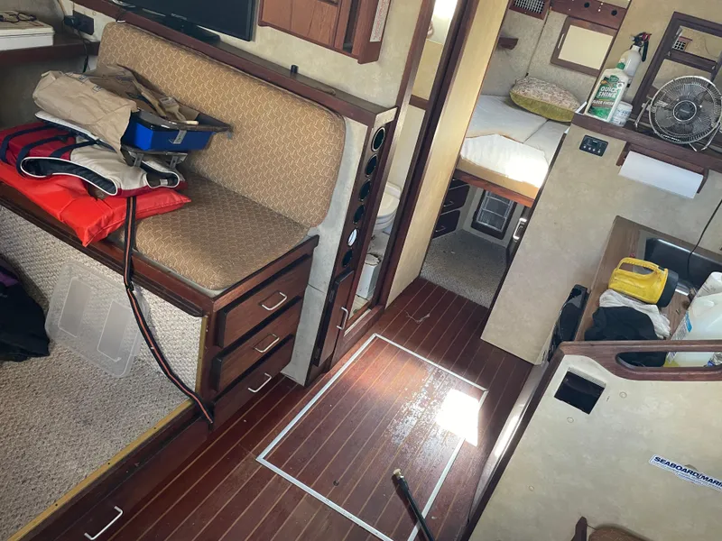 Slide: The Image of Interior of 1983 Luhrs 340 boat with seating, bed, and storage areas. - 19