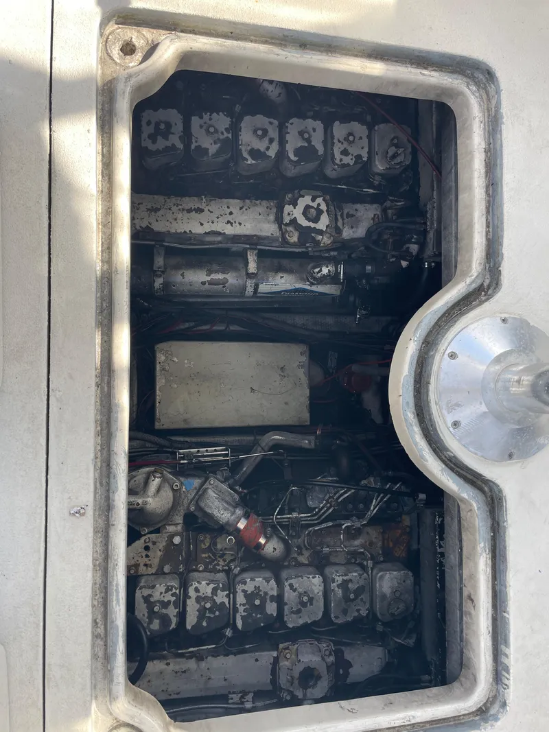 Slide: The Image of Engine compartment of a 1983 Luhrs 340 boat, showing mechanical components and wiring. - 20
