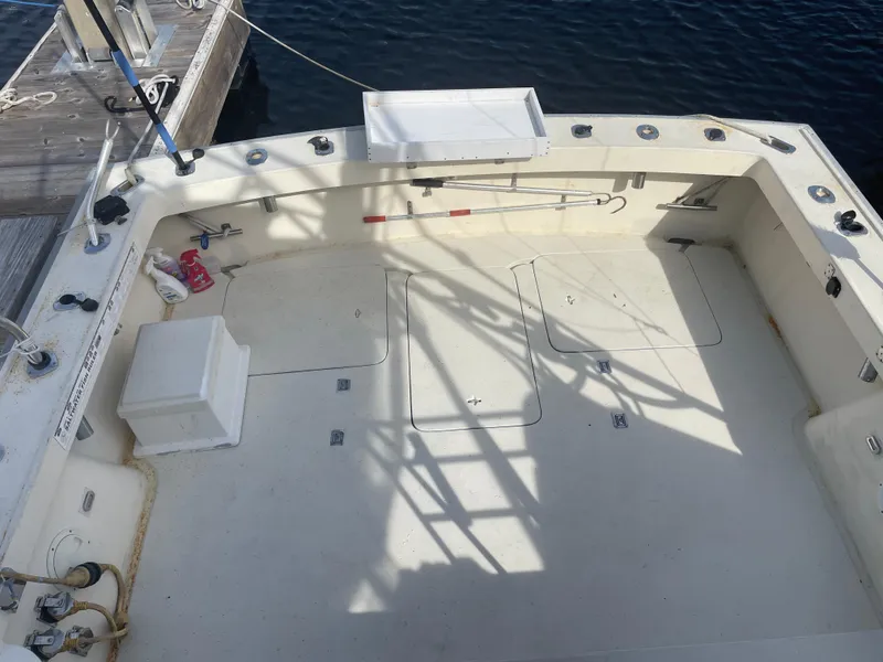 Slide: The Image of 1983 Luhrs 340 boat deck with fishing rod holders and storage compartments. - 8