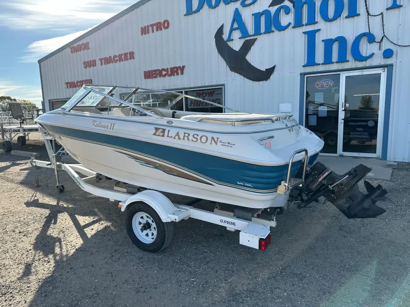 Slide: The Image of 1995 Larson 174 SEI boat on trailer outside dealership, sunny day. - 1