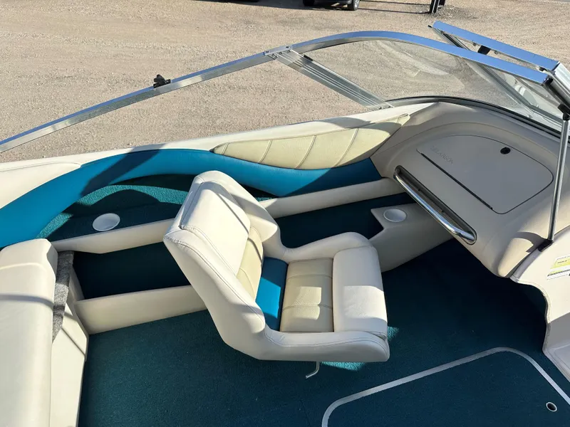 Slide: The Image of Interior of a 1995 Larson 174 SEI boat with white and blue seating. - 10