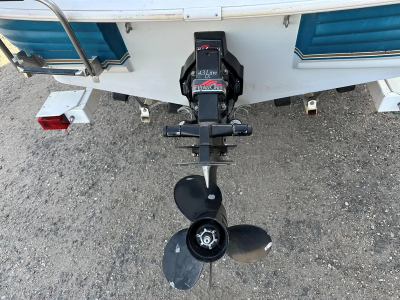 Slide: The Image of 1995 Larson 174 SEI boat stern with propeller and outboard motor. - 2